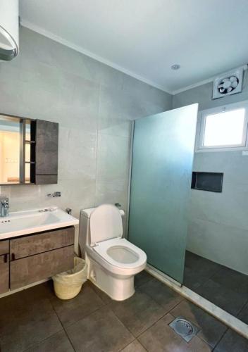 Al Qarāḩīnبيات للنزل السياحية的浴室配有卫生间、盥洗盆和浴缸。