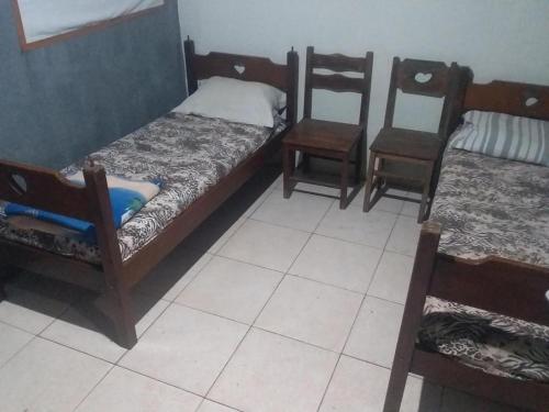 里约达欧特拉斯EL CALEUCHE的带三张双层床和两把椅子的房间