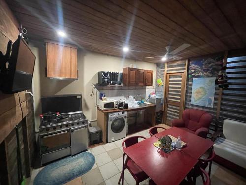 圣多美RALUX house的一间小厨房,内设红色的桌子和椅子