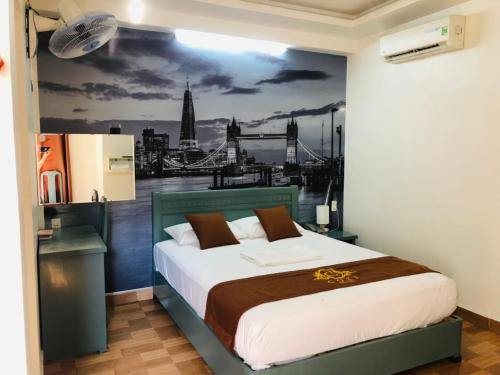 海防科济酒店的一间卧室配有一张壁画床