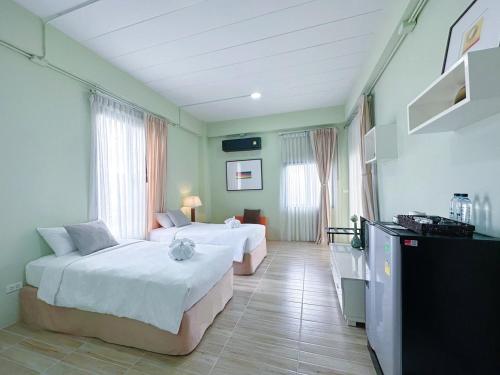 拉廊Daddy Dream Hotel and Residence的酒店客房设有两张床和电视。