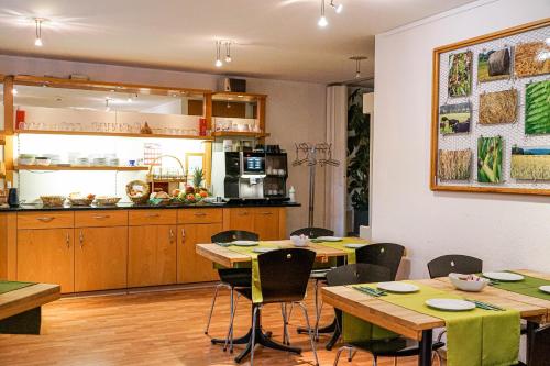 巴瑟尔斯多夫Centra Hotel Zurich的厨房以及带木桌和椅子的用餐室。