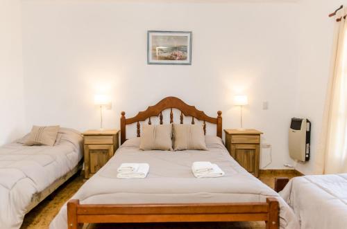 维拉卡洛斯帕兹del Buen Ayre的一间卧室配有两张带毛巾的床