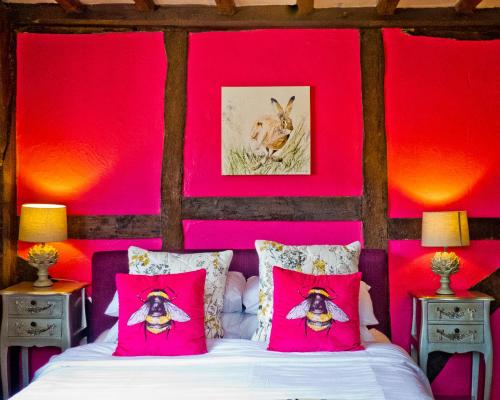 奥尔弗里斯顿叶奥尔德走私者宾馆的卧室拥有粉红色的墙壁,配有一张带粉红色枕头的床
