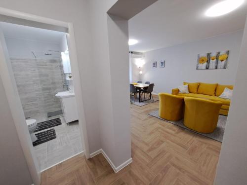 帕利克Apartments Manna Palic的客厅配有黄色的沙发和桌子