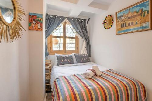 丹吉尔Dar BAB HAHA Petite Maison à la Marocaine的一间卧室设有一张床和一个窗口