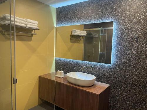 马尔萨斯卡拉Luxurious sunlit maisonette with large terrace!的一间带水槽和镜子的浴室