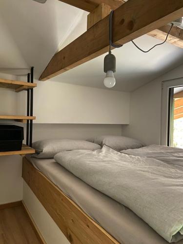 埃京Modernes Tinyhouse Trailer Cabins am Waldrand - mit Seezugang的一间卧室配有一张木架大床