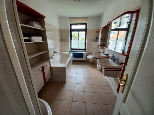茨维考L118 Vermietungen的一间带两个盥洗盆、浴缸和卫生间的浴室