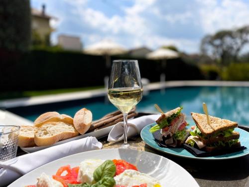拉莫拉科尔特贡迪亚精品酒店的一张桌子,上面放着两盘食物和一杯葡萄酒