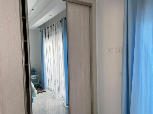 拉马萨Marsa Central Splendid Appart 2的镜子,走廊上设有窗帘