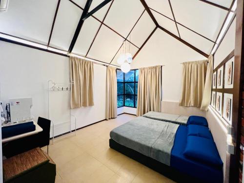 居銮KASIH SAYANG Farmstay山下人家的一间卧室设有一张大床和一个窗户。