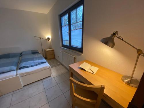 汉堡Elbinsel-Home ‘Alpakaliebe’的一间卧室配有一张床和一张带台灯的书桌
