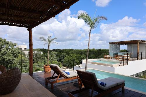 图卢姆Rosa Azul Tulum的一个带椅子的庭院和一个游泳池