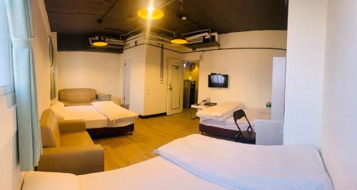 台南驿家旅店的一间医院间,配有两张床和一张沙发