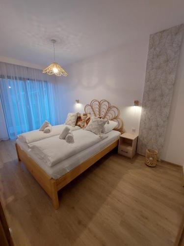 卡尔帕奇Apartament Pod Papugami 2 Karpatia Resort的一间卧室配有一张大床和木制床头板