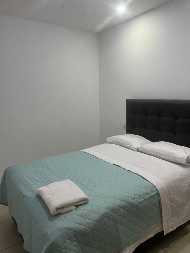伊察Apartamento en Ica 2的白色卧室配有一张带蓝色毯子的床