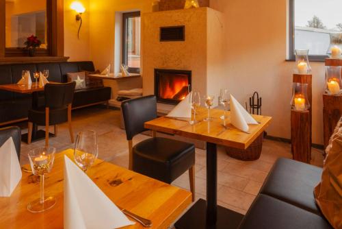 俄伦比斯费佛达尔旅馆酒店的一间带壁炉和桌椅的餐厅