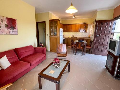 哈尔基斯Lefkandi Family House的客厅配有红色的沙发和桌子