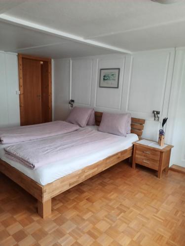GaisVreni`s Ferienwohnung的卧室配有一张带白色床单和粉红色枕头的大床。