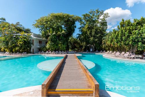 璜多里奥Beach Apartment Villas Jubey, Emotion access的度假村内带木板路的游泳池