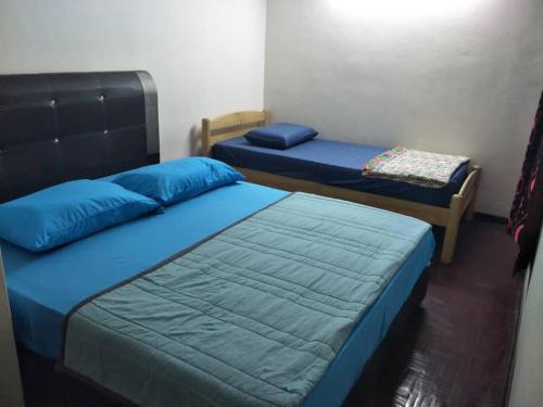 波德申Sharaa seaview Apartment的配有蓝色枕头的客房内的两张床