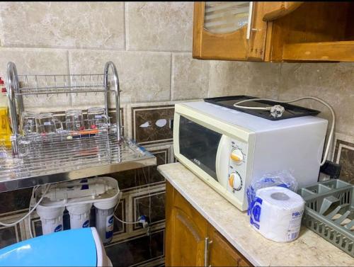 开罗Dreams House in Maadi的厨房的台面上有一个微波炉