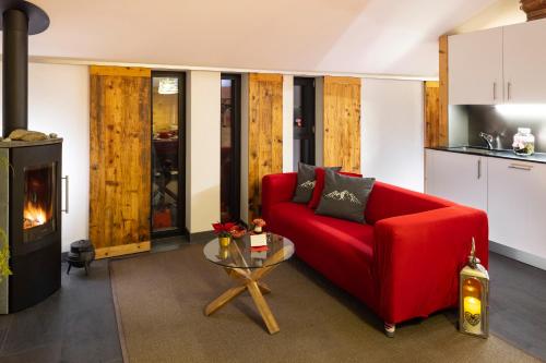 威拉尔-苏-罗伦珀蒂特格兰奇度假屋的客厅配有红色的沙发和桌子