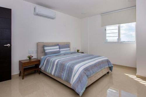 坎昆Amara, depa con vista al mar的一间白色卧室,配有床和床头柜
