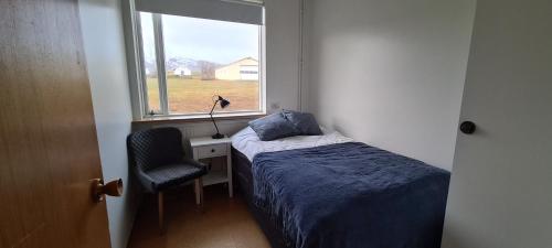 GlaumbærHátún的一间小卧室,配有床和窗户