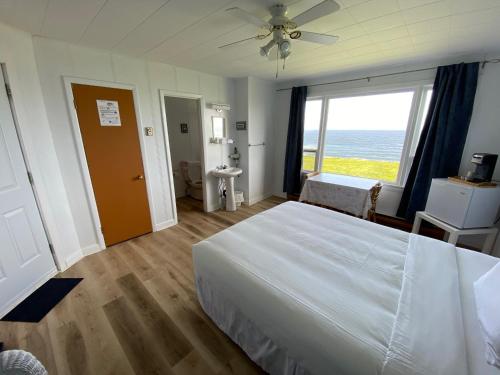 Pointe a la Fregate北极星餐厅汽车旅馆的一间卧室设有一张大床和一个大窗户