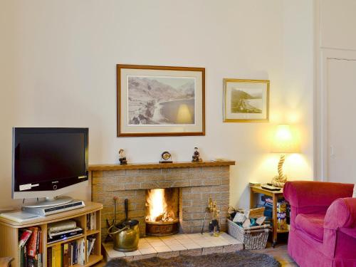 ArnisdaleBrightwater Cottage的一间带电视和壁炉的客厅