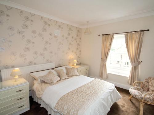 马特洛克Linden Cottage - E2549的白色的卧室设有床和窗户