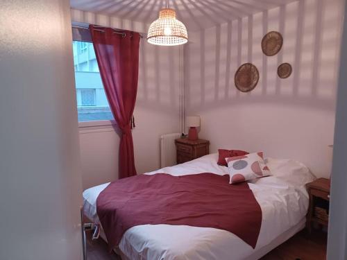 勒阿弗尔Le François 1er : Au cœur de la ville, côté mer的一间卧室配有一张带红色窗帘的床和窗户