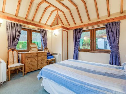 Kintail科雷根鲁德乡村别墅的一间卧室配有一张床、梳妆台和窗户。