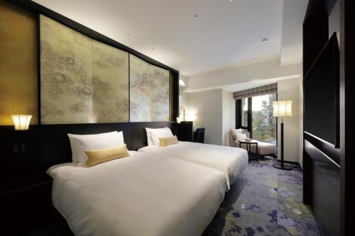 金泽金泽山乐酒店的一间卧室设有两张床和一张白色大床