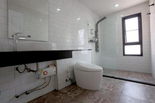 清迈TarTar & Nay Hostel的白色的浴室设有卫生间和水槽。