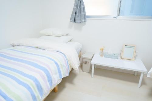 大阪Osaka - House - Vacation STAY 8920的白色卧室配有床和桌子