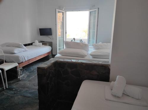 科里夏Kea Island II的带三张床和窗户的客房