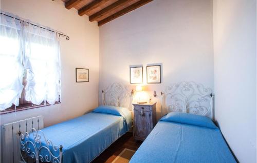 蒙米奥La Piana的卧室设有两张床,配有蓝色的床单和窗户。