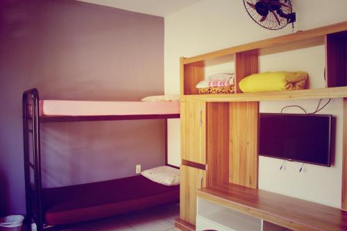弗洛里亚诺波利斯Hostel Nossa Casa的客房设有双层床和电视。