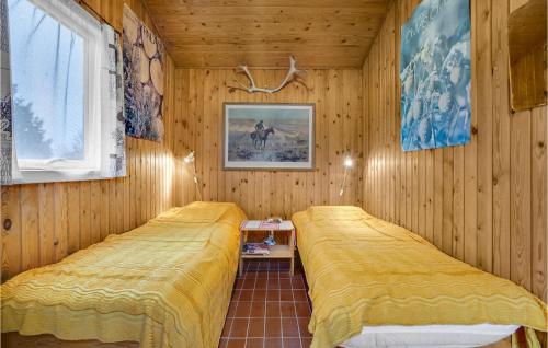 霍尔拜克Nice Home In Holbk With Kitchen的木墙客房的两张床