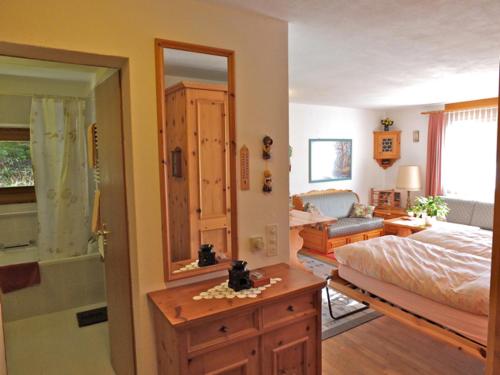 马洛亚Pra d'Sura 104的一间带一张床的卧室和一间带镜子的浴室