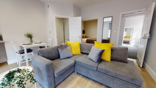 考文垂1 Castle Yard的客厅配有带黄色枕头的灰色沙发