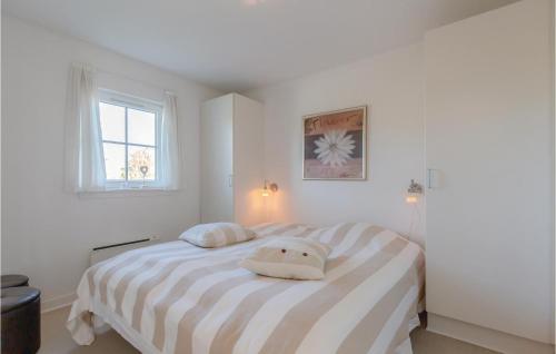 布罗3 Bedroom Lovely Home In Brenderup Fyn的白色卧室配有带两个枕头的床