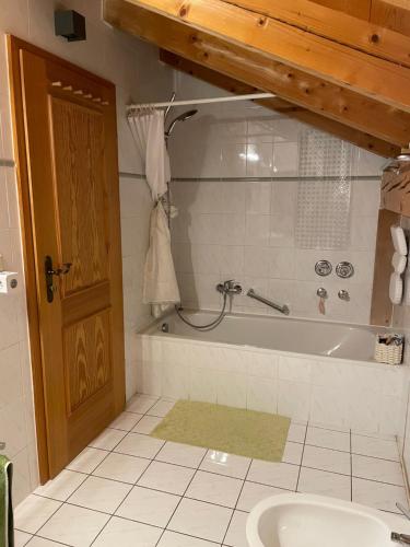 法尔先特Dachgeschosswohnung mit traumhaftem Zugspitzblick bei Garmisch的带浴缸和盥洗盆的浴室