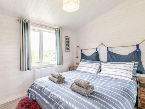 WillingtonErica Lodge的卧室配有蓝色和白色的床,提供毛巾
