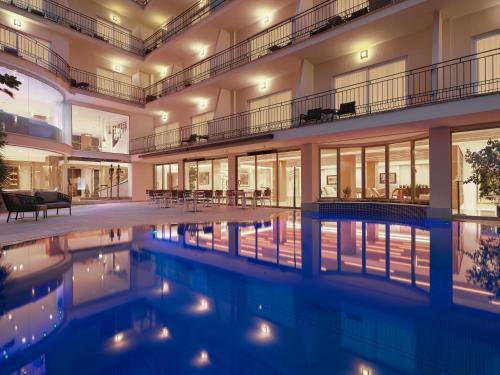 马略卡岛帕尔马萨拉托加酒店的享有带游泳池的建筑的外部景色