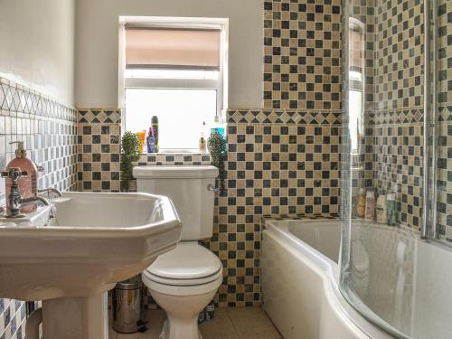 斯托克布里奇Willow Cottage的浴室配有卫生间、盥洗盆和浴缸。