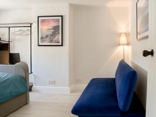 哈瑟西奇Morton Loft的一间卧室配有蓝色椅子和一张床